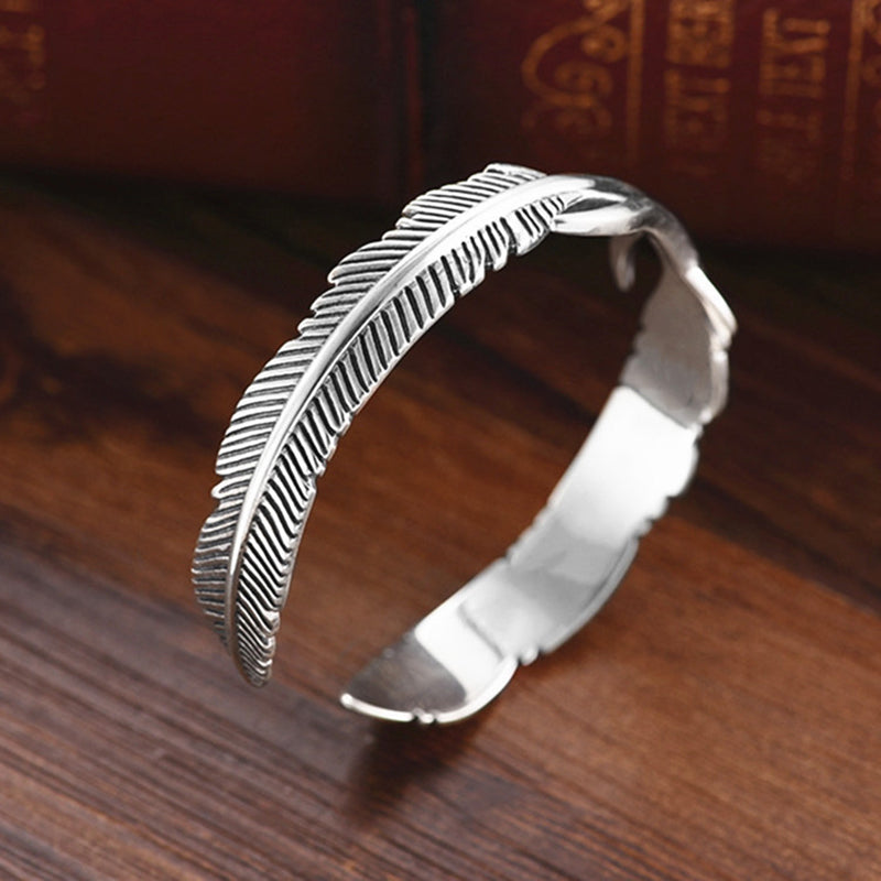 Mansjettarmbånd med gjennombrutt fjærdesign i sterling