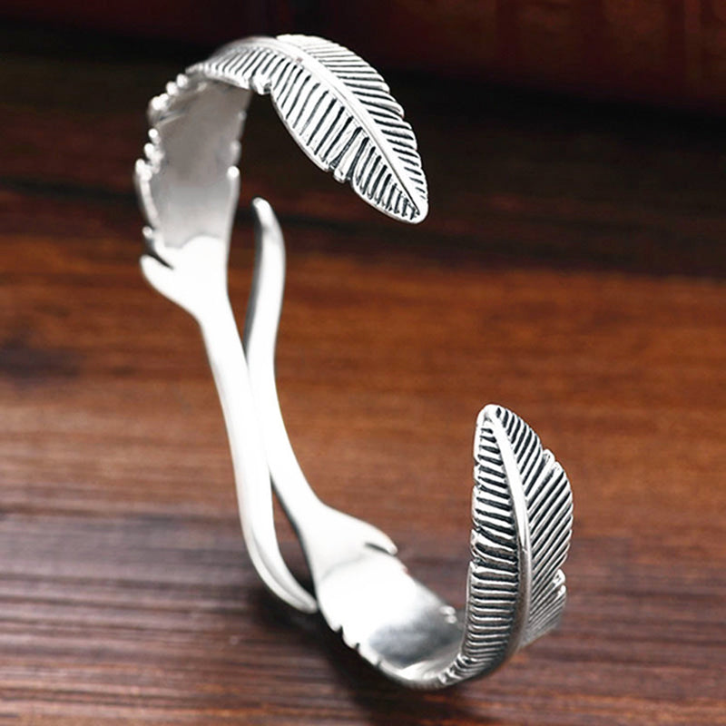 Mansjettarmbånd med gjennombrutt fjærdesign i sterling