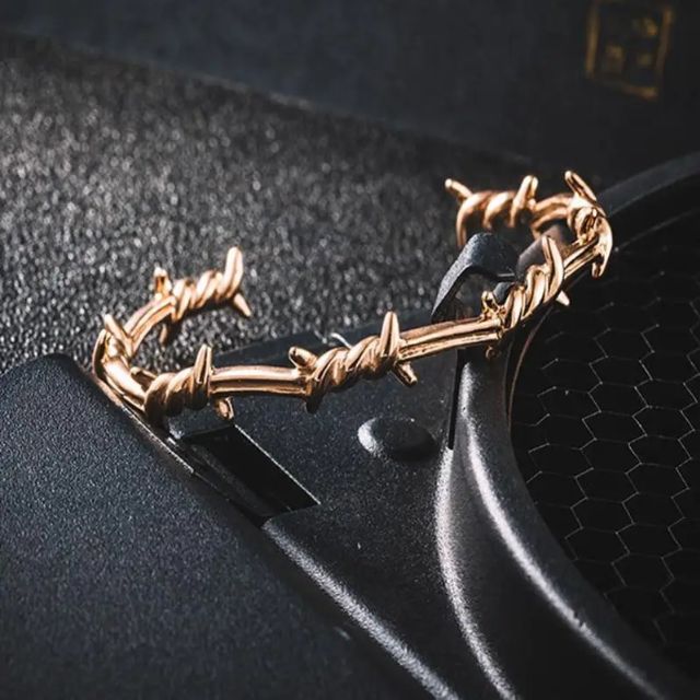 Mansjettarmbånd med gjennombrutt fjærdesign i sterling