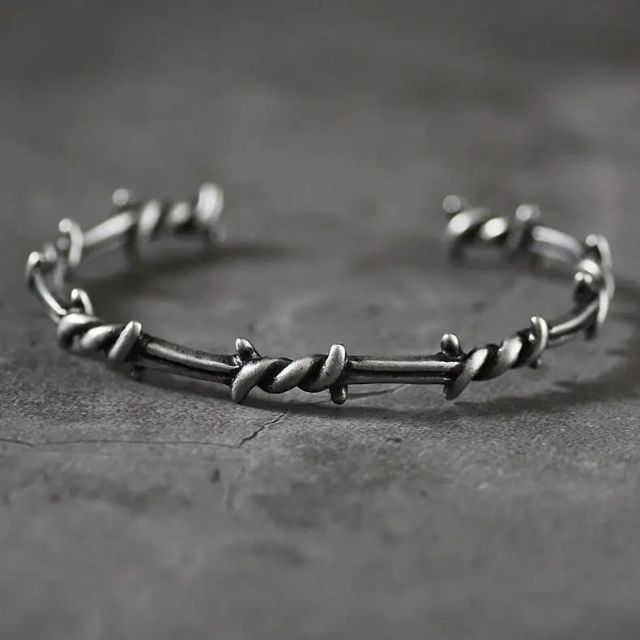 Mansjettarmbånd med gjennombrutt fjærdesign i sterling