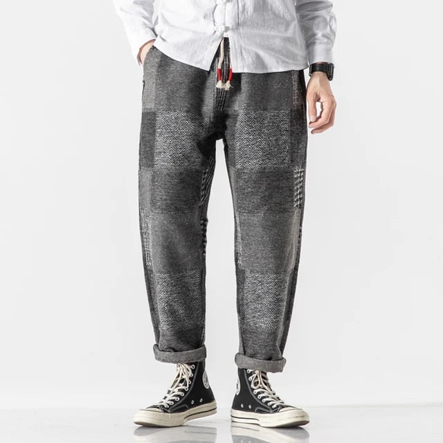 Joggers i bomull med lappeteppe-panel