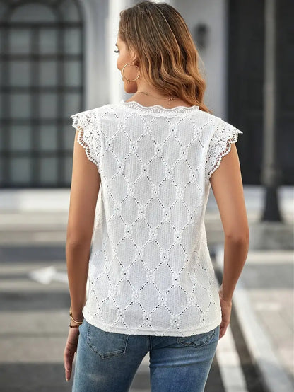 Ensfarget, blomstrete bluse med V-hals og blondebroderi